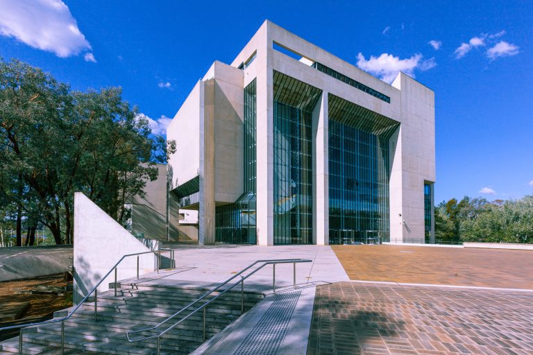 The High Court of Australia in Canberra, seen from the forecourt under a blue sky