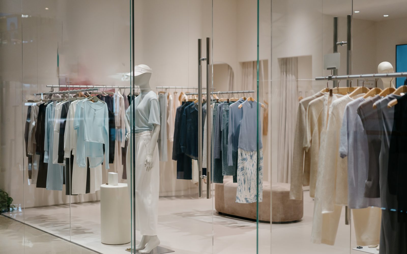 Fashion boutique interior with garment rails and mannequins