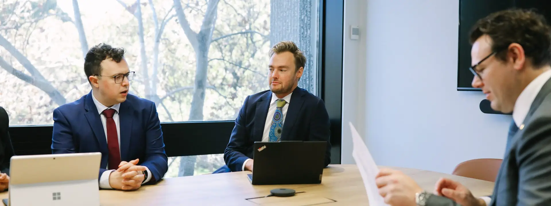 Three Boettcher Law lawyers working through a matter in the meeting room