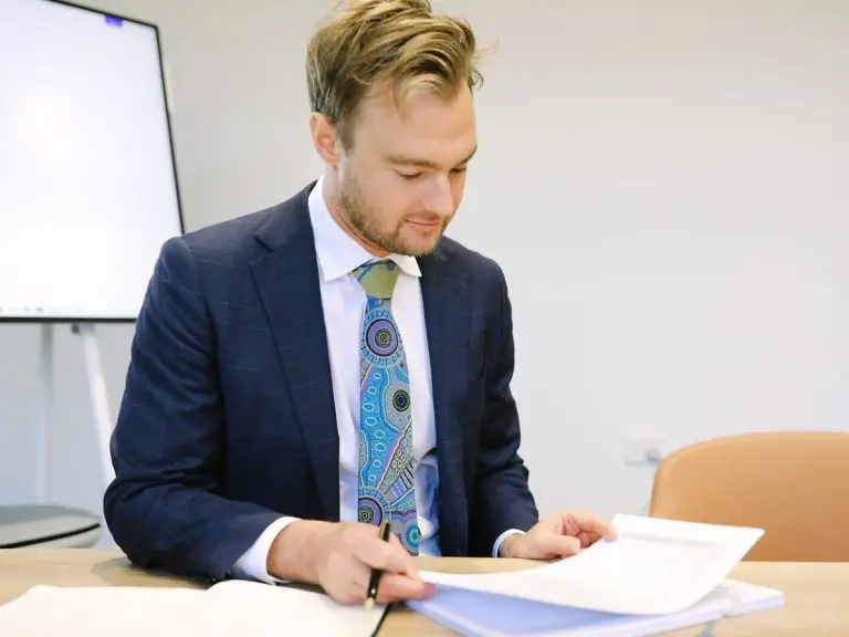 A Boettcher Law solicitor marking up a document at the meeting table