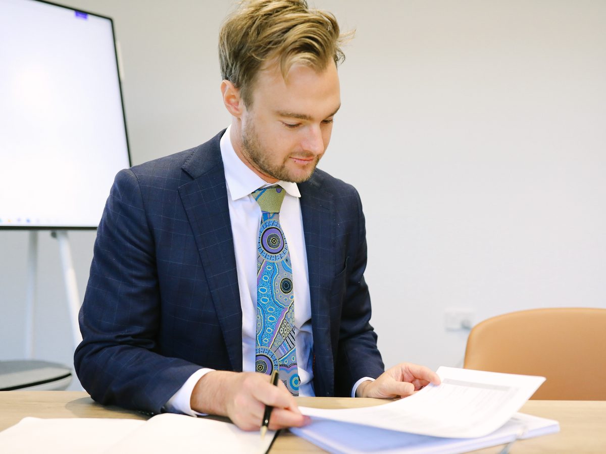 A Boettcher Law solicitor marking up a document at the meeting table