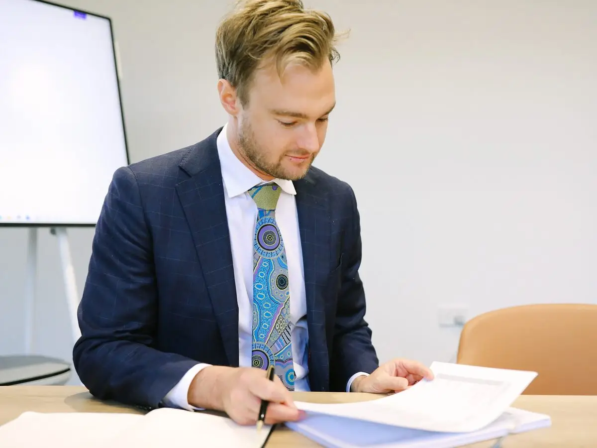 A Boettcher Law solicitor marking up a document at the meeting table