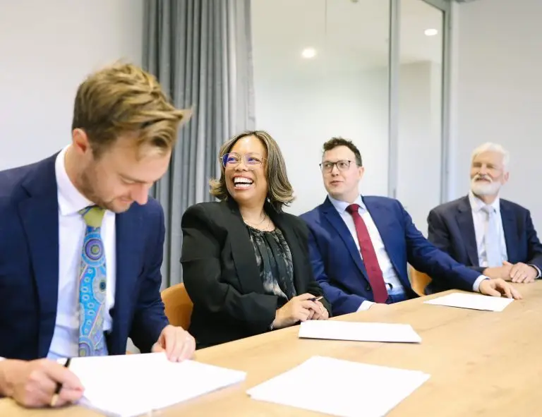 Four Boettcher Law colleagues around the meeting room table at the firm Canberra office