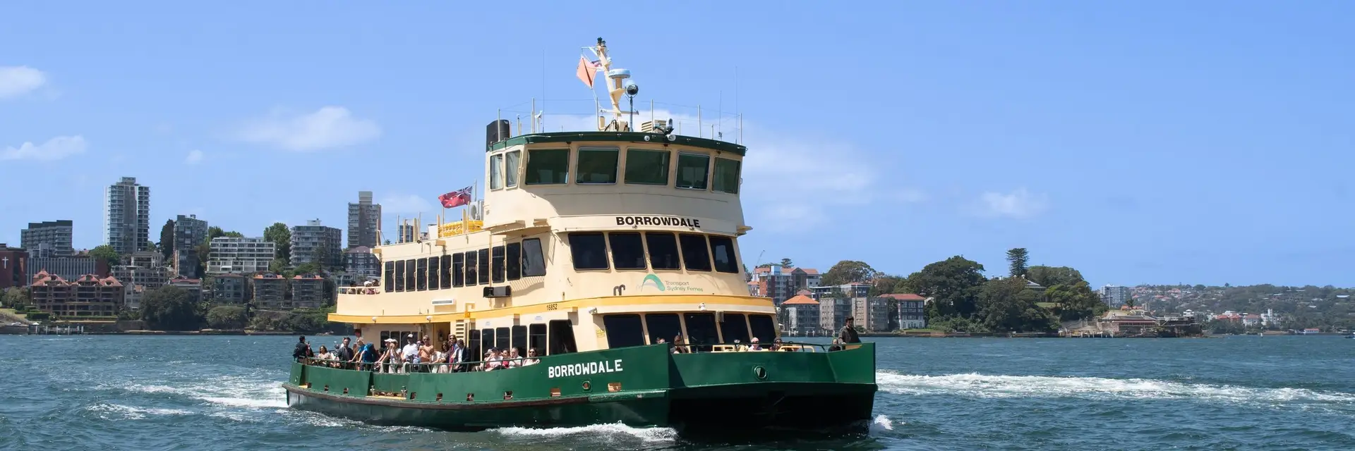 A Sydney Harbour ferry under way with the northern shore behind