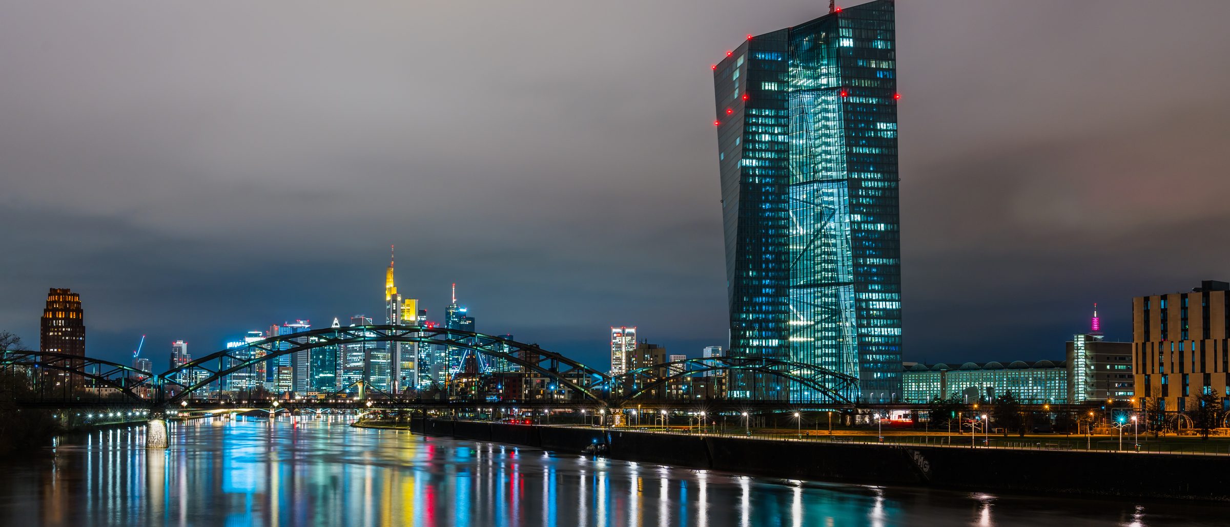 The European Central Bank tower above the Main in Frankfurt at night