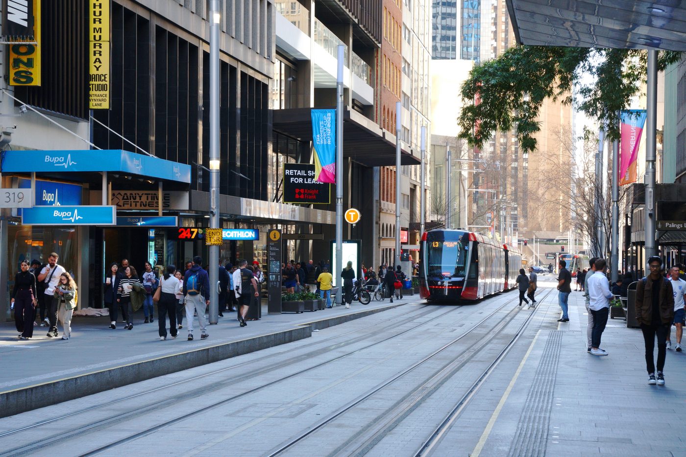A light rail tram and pedestrians on George Street in the Sydney city centre