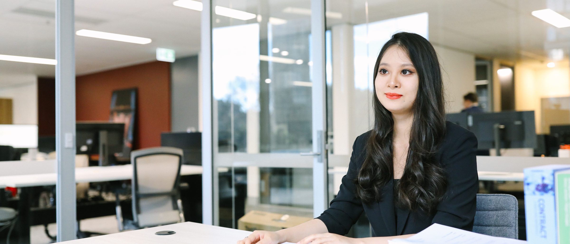 A lawyer working through a contract and supporting documents at a desk