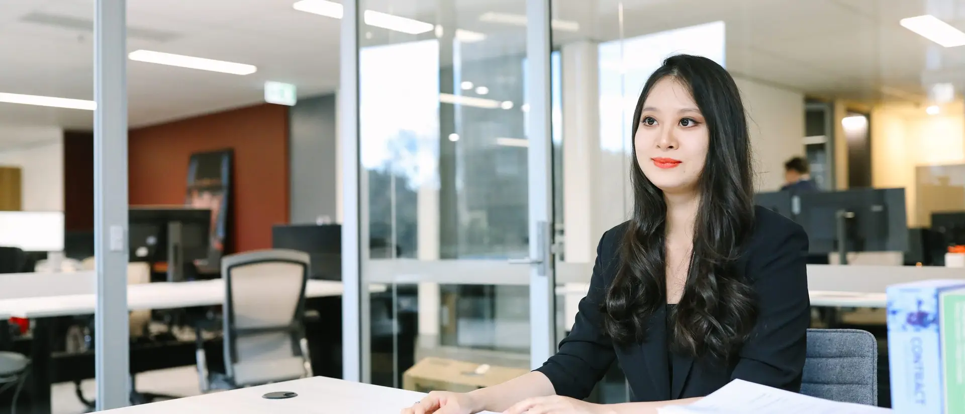 A lawyer working through a contract and supporting documents at a desk
