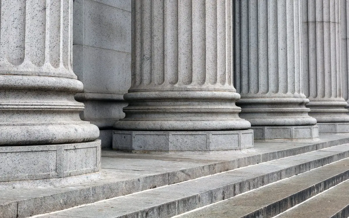 Row of classical stone columns on their bases above a flight of steps