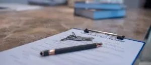 House keys resting on a purchase agreement, the overseas property a will has to reach