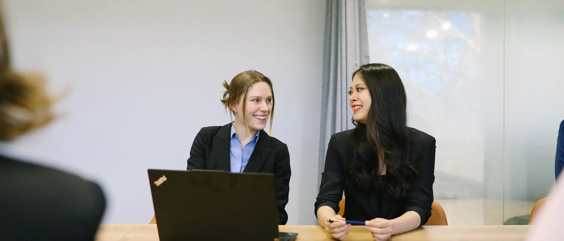 Two Boettcher Law colleagues reviewing documents together at a meeting table