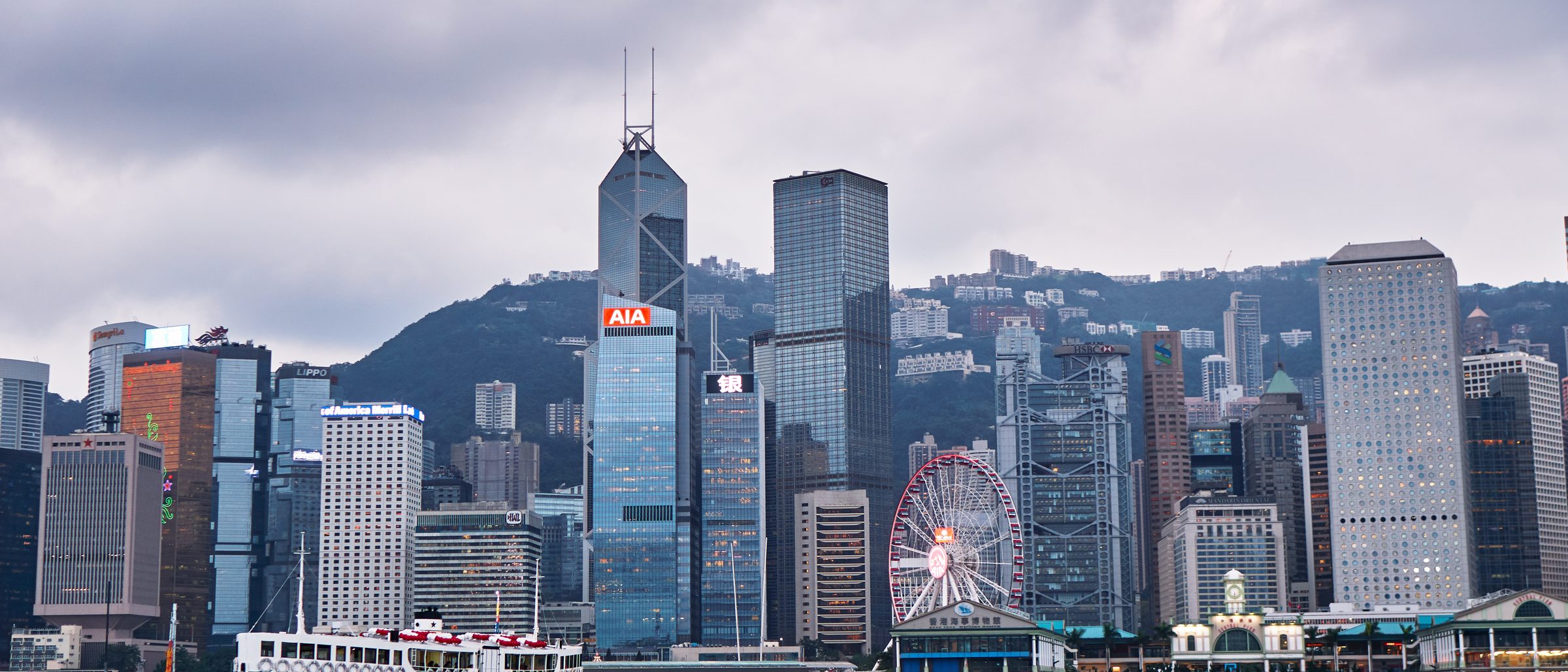 Hong Kong Central skyline across Victoria Harbour with a Star Ferry crossing, the forum named in the exclusive jurisdiction clause